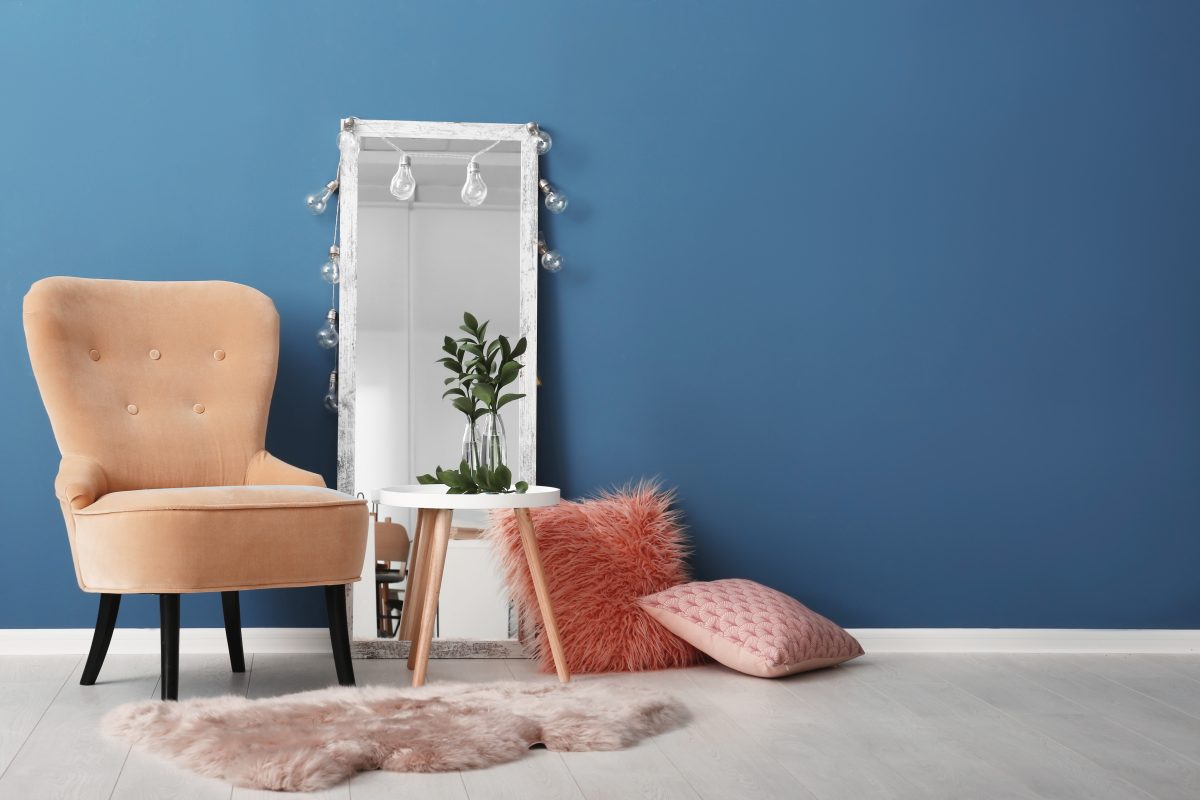 A room of home decor items against a blue wall