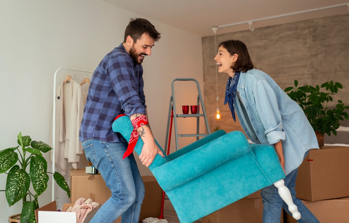 A couple arranging the furniture in their living space