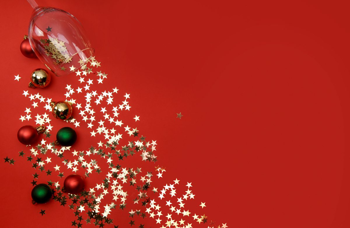 glitter and Christmas decorations spilled from a glass of wine