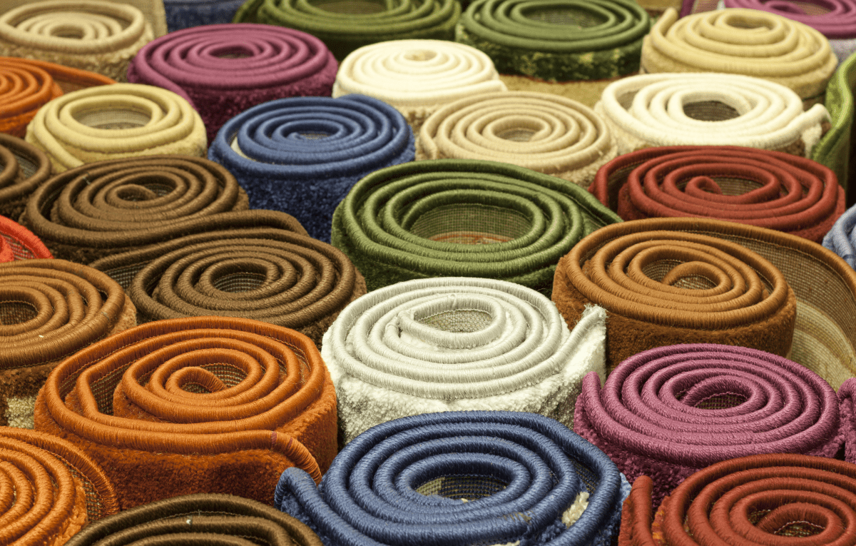 rolls of different types of colourful carpets